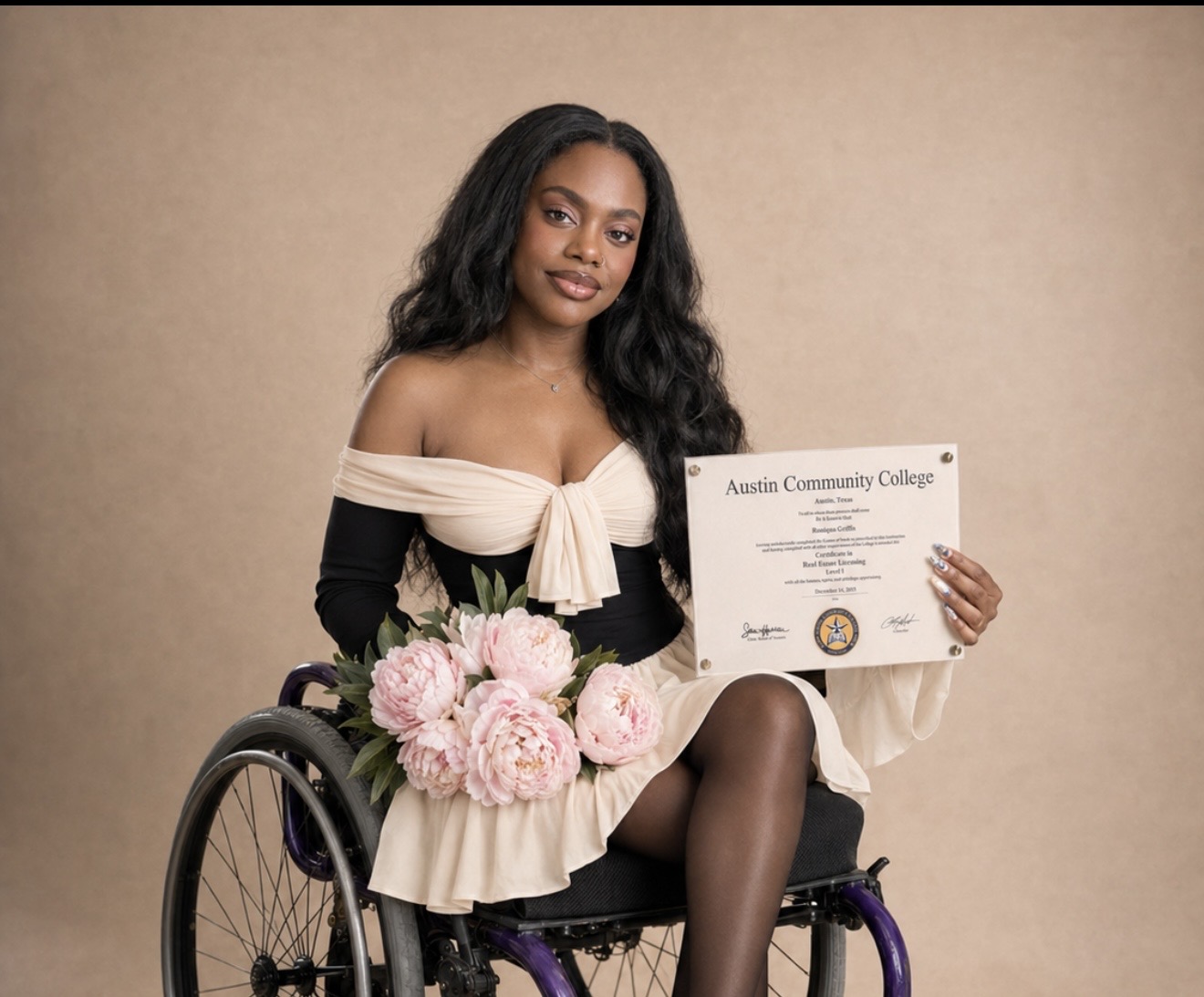 Young woman in a wheelchair holding a diploma and pink flowers, smiling, against a beige background.
